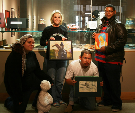 From left to right, Hannah Mathews of Senatobia, Andrea Haynes of Cleveland, Richard Shue of Jackson, and George Johnson of Greenville, prepare for the annual student art show.